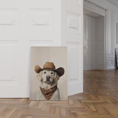 a white dog wearing a cowboy hat and bandana in an empty room with wooden floors