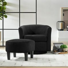 a black chair and ottoman in a living room