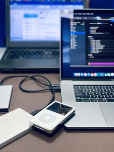 two laptops and an ipod on a table