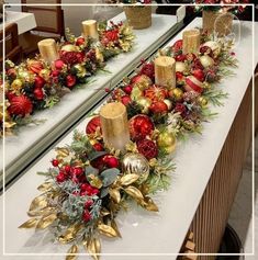 two tables with christmas decorations and candles on them