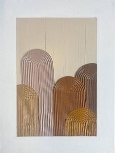 an abstract painting with lines and shapes in gold on white paper, framed against a wall