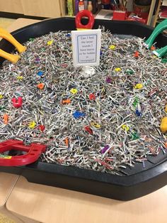 a black tray filled with lots of pins and pliers