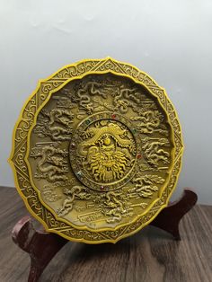 a yellow plate sitting on top of a wooden table