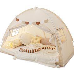 a tent bed with pillows and blankets on it's sides, in front of a white background