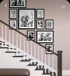 a stair case with many pictures on the wall and some black and white frames above it