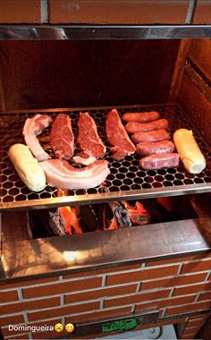 hot dogs and sausages cooking on an outdoor grill