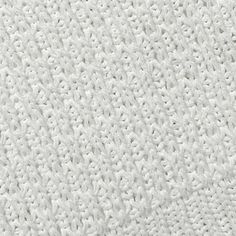 an up close shot of the texture of a white knitted fabric, which is very soft