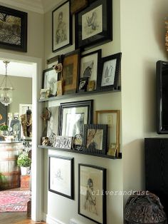 there are many framed pictures on the wall