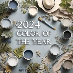 the words, color of the year are surrounded by paint cans and flowers on a blue background