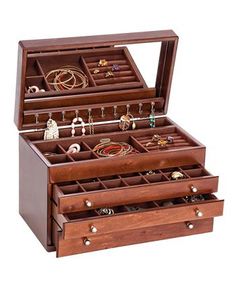 a wooden jewelry box filled with lots of different items