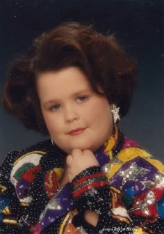 an old photo of a young woman with her hand on her chin