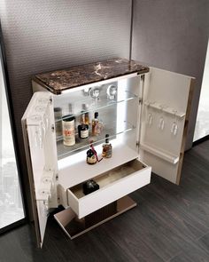 an open cabinet with liquor bottles in it