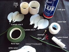 the supplies needed to make paper flowers are laid out on a black table with instructions