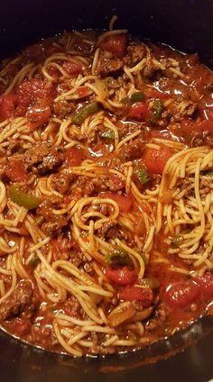 a pot filled with spaghetti and meat in sauce