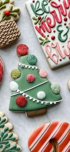 decorated christmas cookies are arranged on a table