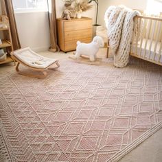 a baby's room with a crib, rocking horse and other items on the floor