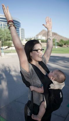 a woman holding a baby up in the air