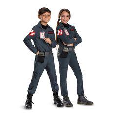 two children dressed in police uniforms posing for the camera with their hands on their hips