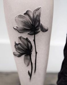 black and white flower tattoo on the leg