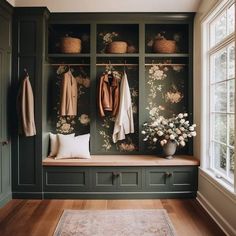 a room with green cabinets and flowers on the wall