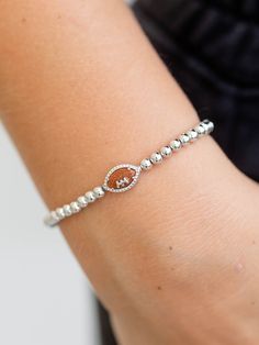 This stretchy, metal beaded bracelet features a small football charm to add the perfect touch to any game day look. Perfect for sports moms or fans in general, this football bracelet is simply adorable. Broncos Bracelet, Metal Bead Bracelet, Football Bracelet, Bridal Shower Outfit, Athleisure Fashion, Capri Blue, Cold Weather Accessories, Gift Accessories, Metal Beads