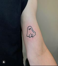 a small ghost tattoo on the arm