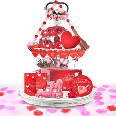 a valentine's day cake with hearts, flowers and decorations on the top tier