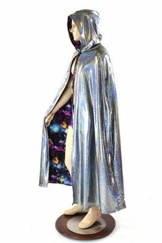 a mannequin dressed in shiny silver clothing with a hood and cape over it