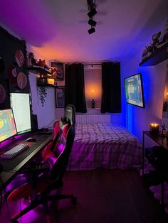 a bed room with a neatly made bed and two monitors