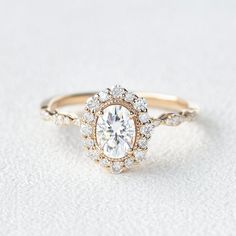 a diamond engagement ring on a white surface