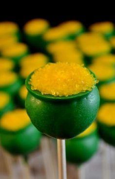 there are many green and yellow cupcakes on sticks