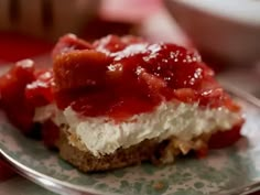 a piece of cheesecake with strawberry topping on a plate