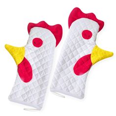 two oven mitts with red and yellow roosters on them, sitting side by side