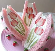 there is a cake with strawberries on it and frosting in the shape of flowers