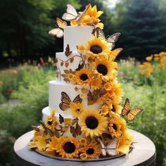 a wedding cake with sunflowers and butterflies on it