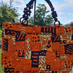 Adametu Collection Quilted Earth Toned Print Ankara Tote Bag . Cool For This Summer Vacation Or A Overnight Stay. Anything Goes ! Made With A Inside Pocket For Your Keys And Cell Phone. 100%Cotton Fabric Casual Orange Rectangular Satchel, Casual Orange Satchel With Double Handle, Casual Orange Rectangular Shoulder Bag, Orange Rectangular Bag For Daily Use, Orange Tote Bag For Daily Use, Casual Orange Bag With Handles, Casual Orange Shoulder Bag With Handles, Orange Pouch Bag For Vacation, Orange Pouch Bag