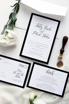 the wedding stationery is laid out on top of the bed with flowers and a wax stamp