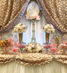 a table topped with lots of flowers and cakes