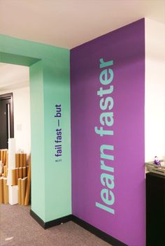 the wall is painted purple, green and blue with white lettering that reads leann fast