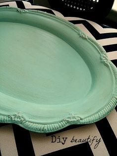 a green plate sitting on top of a black and white table