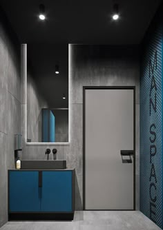 a bathroom with grey walls and blue cabinets