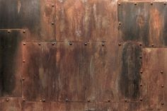 an old rusted metal wall with rivets on it