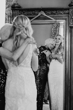 the bride is hugging her mother as she gets ready to walk down the aisle