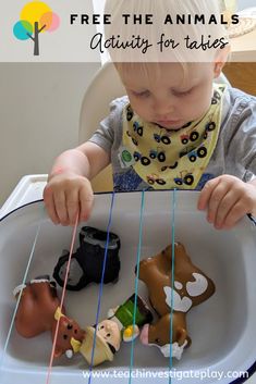 a little boy playing with toy animals in a tray that says, free the animals activity for babies