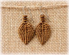 earrings made from seed beads and wooden beads on a piece of burlied fabric