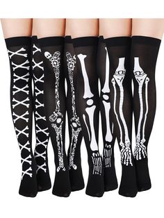 five pairs of stockings with skeleton designs on them, all in black and white colors