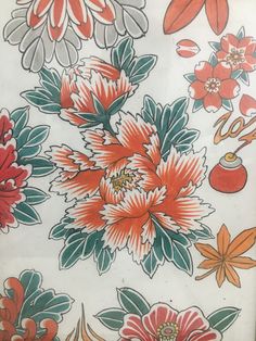 an orange and red flowered design on white fabric