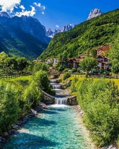 a river running through a lush green hillside