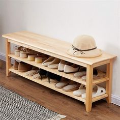 a wooden bench with shoes on it and a hat sitting on top of the bench