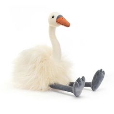 a stuffed animal swan sitting on the ground with its legs spread out and eyes closed